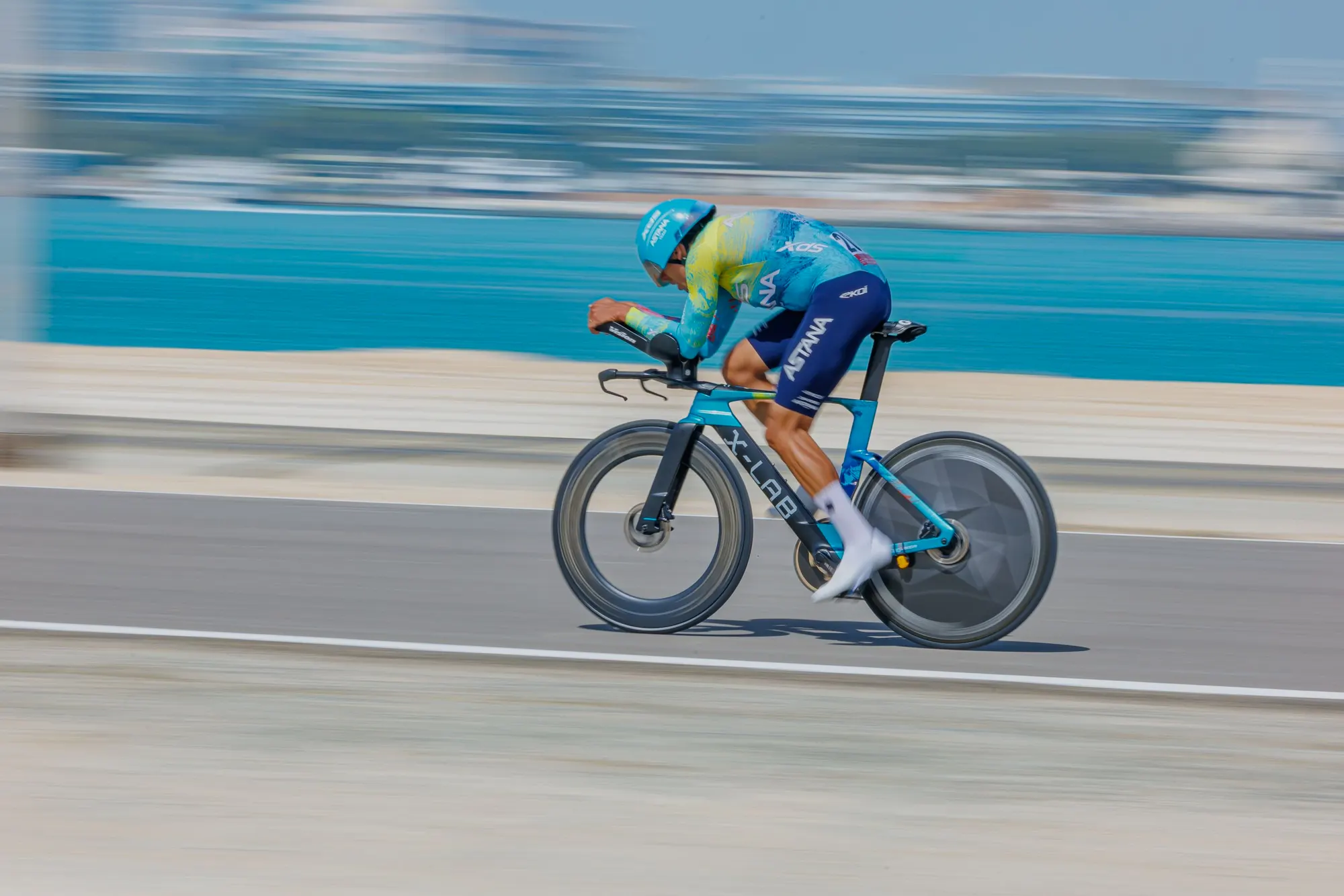 A triathlete riding a time trial bike at speed