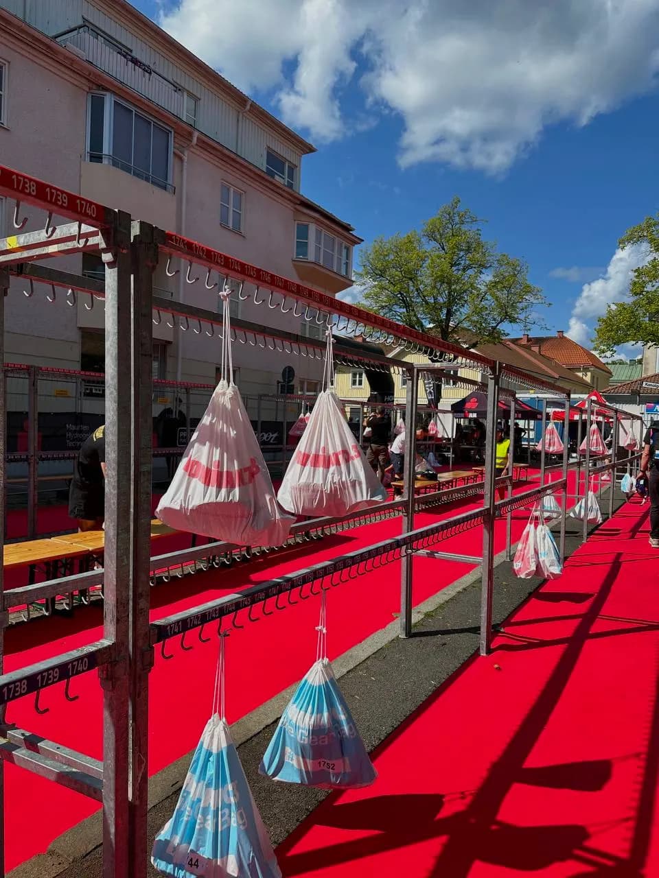 Bags hanging on racks along a transition carpet